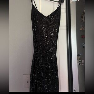 Short black sparkley dress. In perfect condition! Has a tie cross back.
